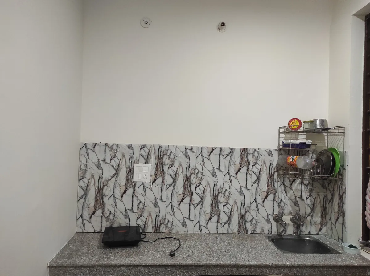 Modern induction kitchen at Daksh Home boys hostel near UPES Kandoli campus