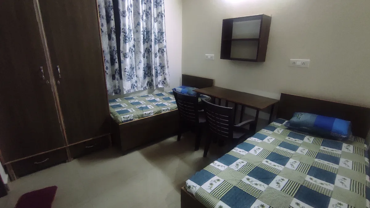 Bright room with large windows at Daksh Home hostel near UPES Knowledge Acres campus